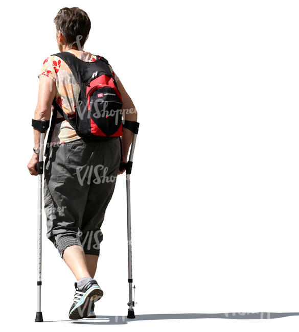 older woman walking with crutches