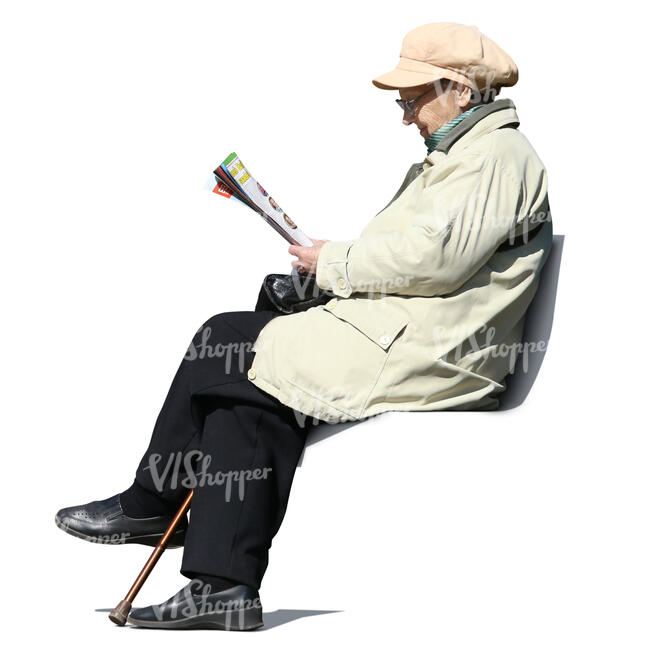 elderly woman sitting in a park and reading newspaper