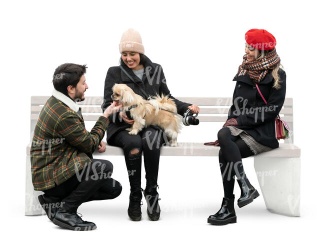 cut out man talking to two women sitting with a dog