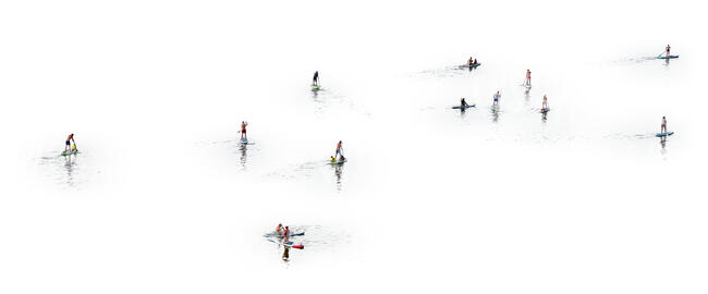 many cut out people paddleboarding seen from above