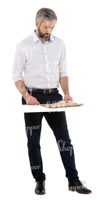 cut out man standing at a table and reading a newspaper