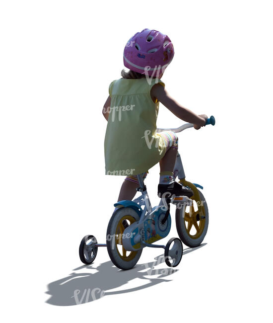 cut out backlit little girl riding a bike