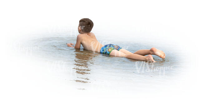 cut out boy lying in the water on the beach