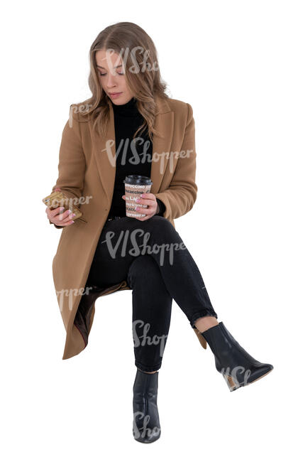 cut out woman in a brown overcoat sitting and drinking coffee