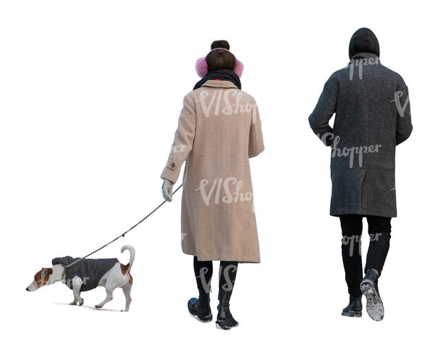 two cut out people walking a dog in winter