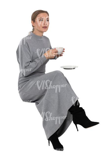 cut out woman in a grey dress drinking coffee in a cafe