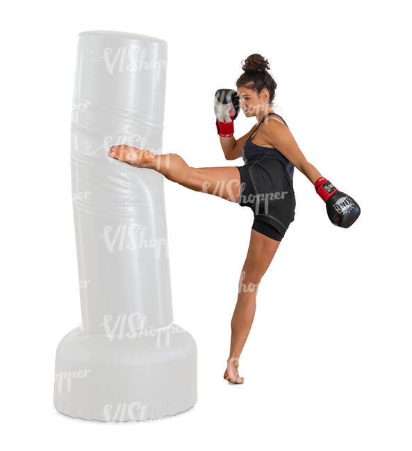 cut out woman at boxing class kicking a punching bag