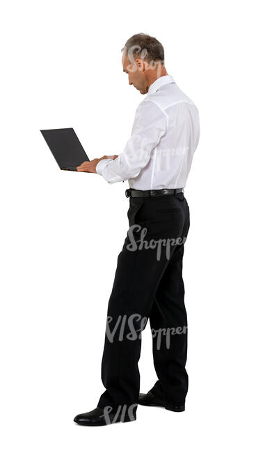 man standing and working with a laptop at a counter