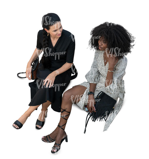 two cut out women sitting seen from above