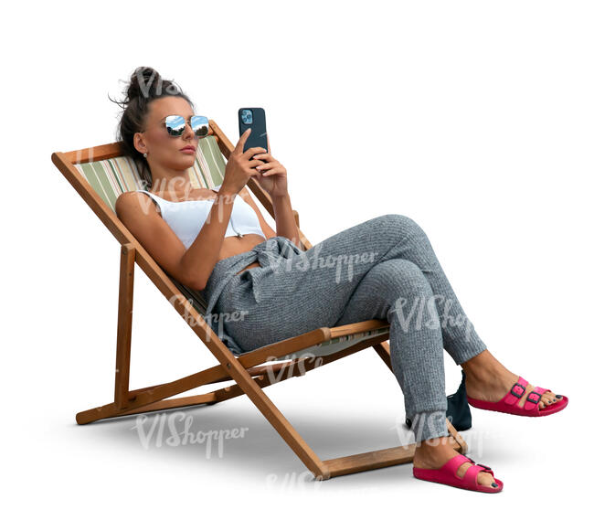 cut out woman lying in a garden chair and texting