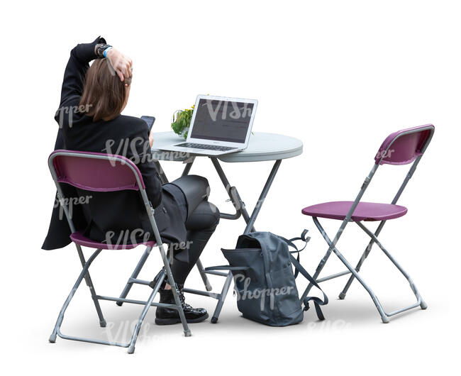 cut out woman sitting at a cafe with a laptop on a table