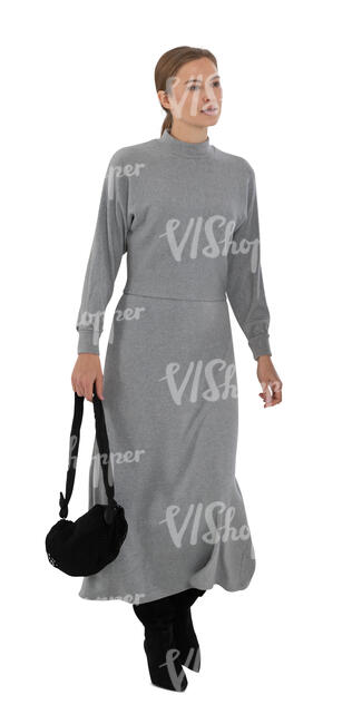 cut out woman in a long grey dress walking