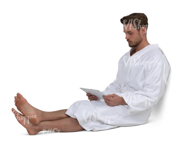 cut out man in a bathrobe sitting and looking at a tablet