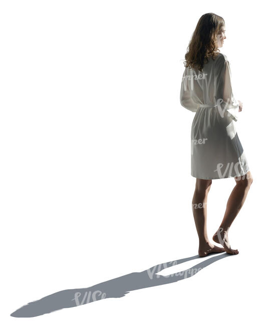 cut out backlit woman in a silky bathrobe standing