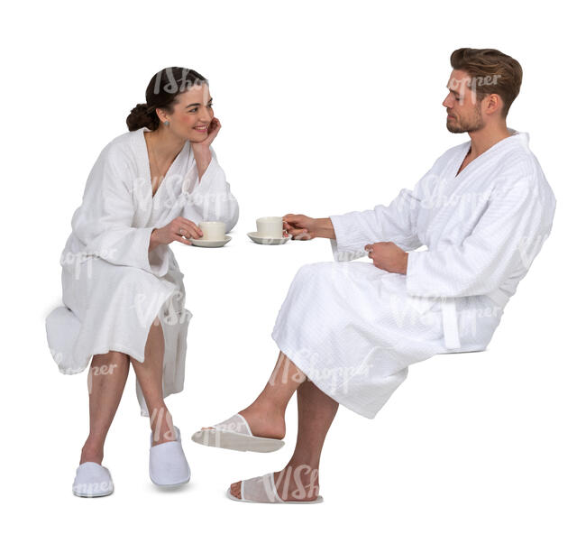 cut out couple in white bathrobes sitting and drinking coffee