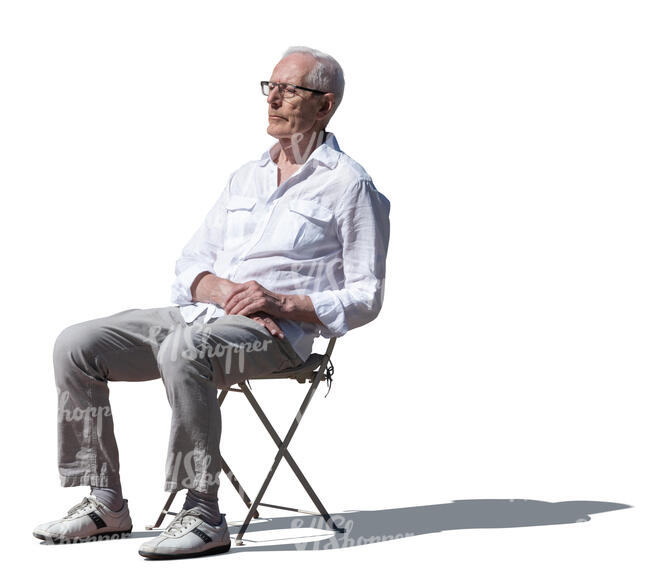 cut out elderly man sitting outside in the sunlight