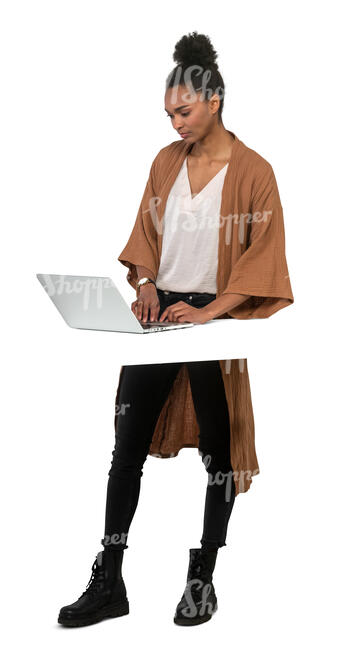 cut out woman standing by a table and working with a laptop