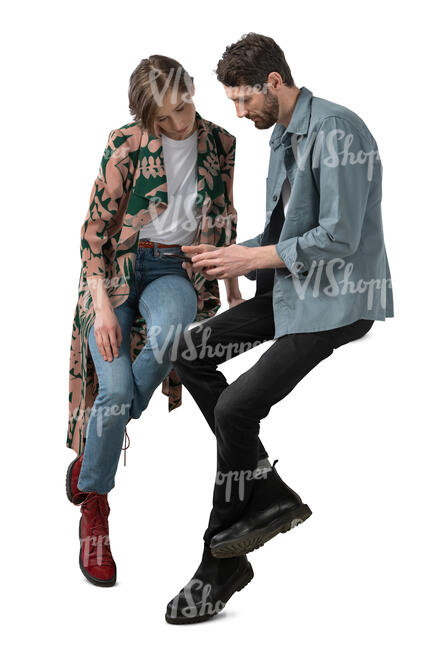 cut out man and woman sitting at a table and looking at phone