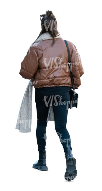 cut out woman in a brown puffer jacket walking