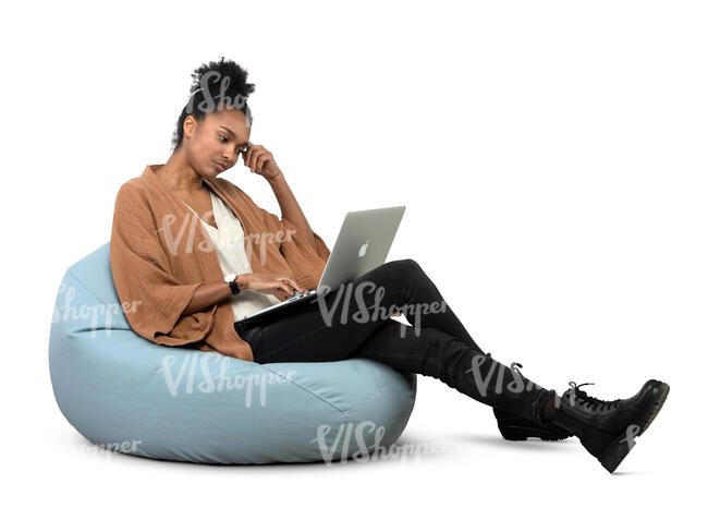 cut out woman sitting on a bean bag and working with laptop