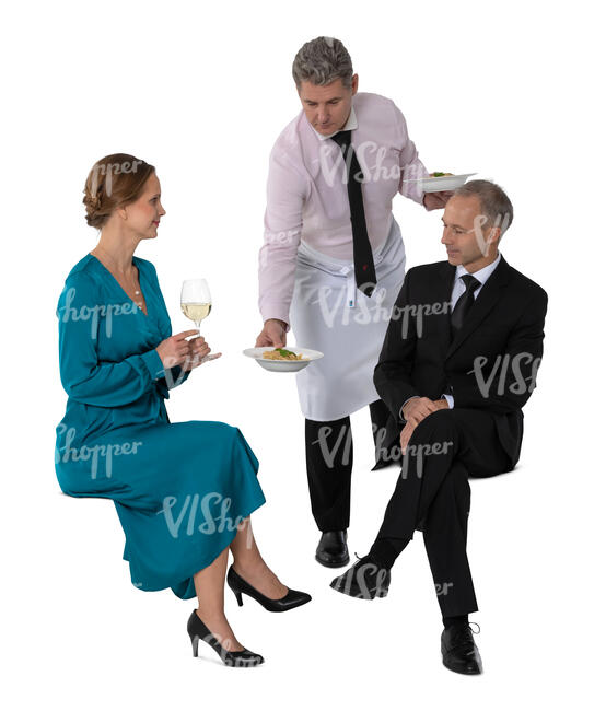 cut out waiter bringing food to two people sitting in a restaurant