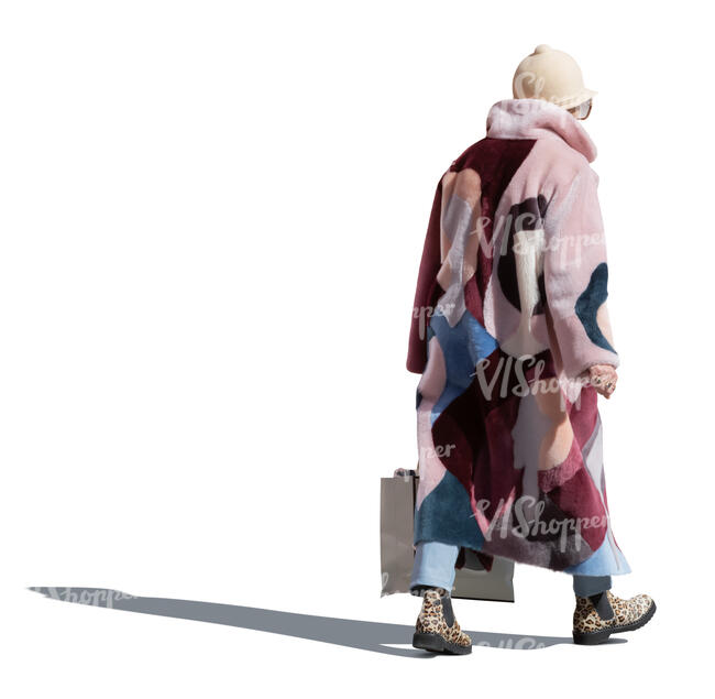 cut out backlit older woman in pink overcoat walking