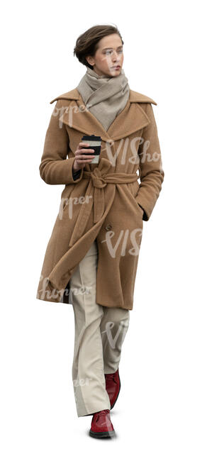 cut out woman in a brown overcoat walking and drinking coffee