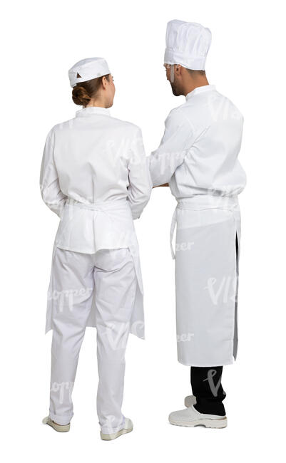 two cut out chefs standing in a restaurant kitchen