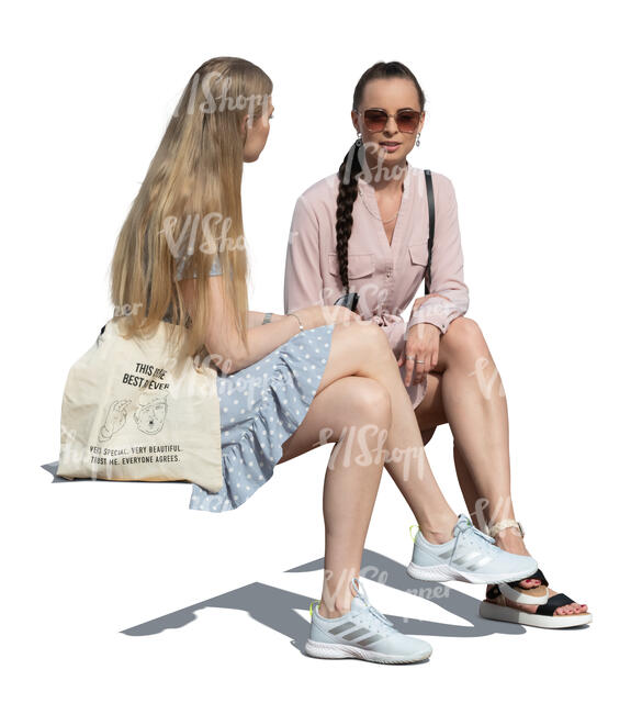 two cut out women sitting and talking