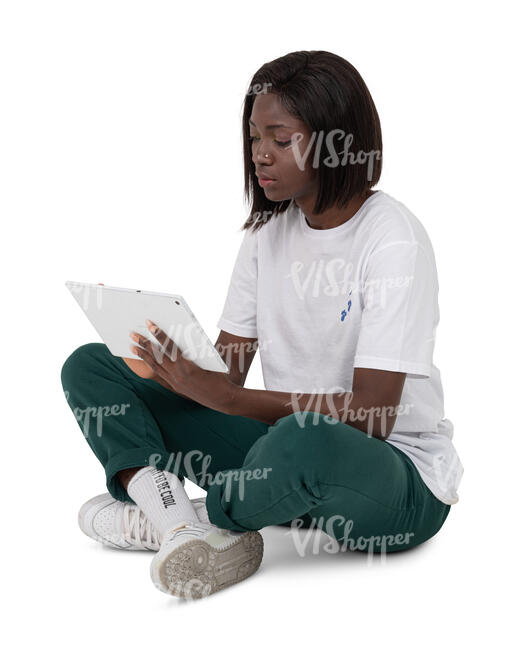 cut out woman sitting on the ground and looking at her tablet