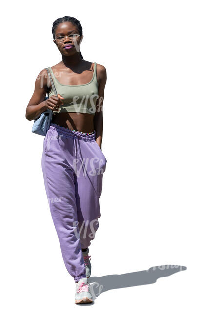 cut out young black woman walking on a summer day