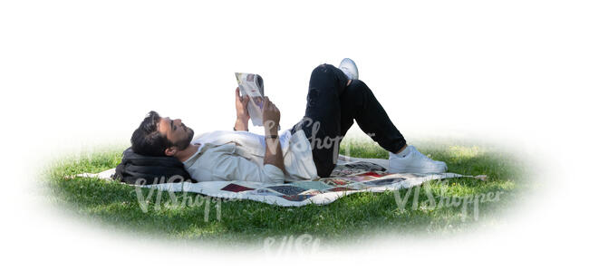 cut out man lying in the tree shade on the grass and reading a newspaper