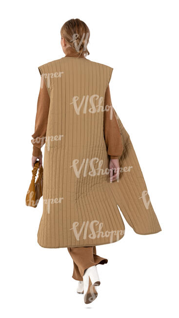 cut out woman in a long beige jacket walking