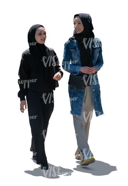 two cut out backlit muslim women walking