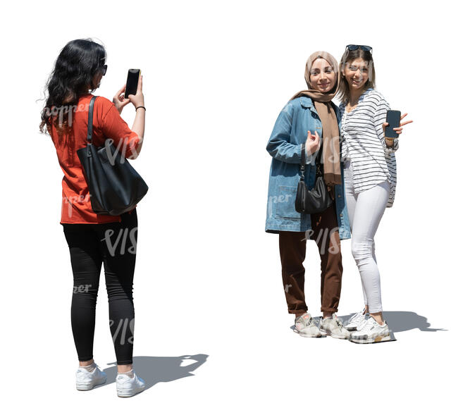 cut out teenage girl taking a picture of her two friends