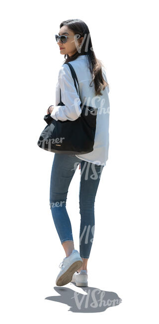 cut out backlit young woman walking and looking back over her shoulder