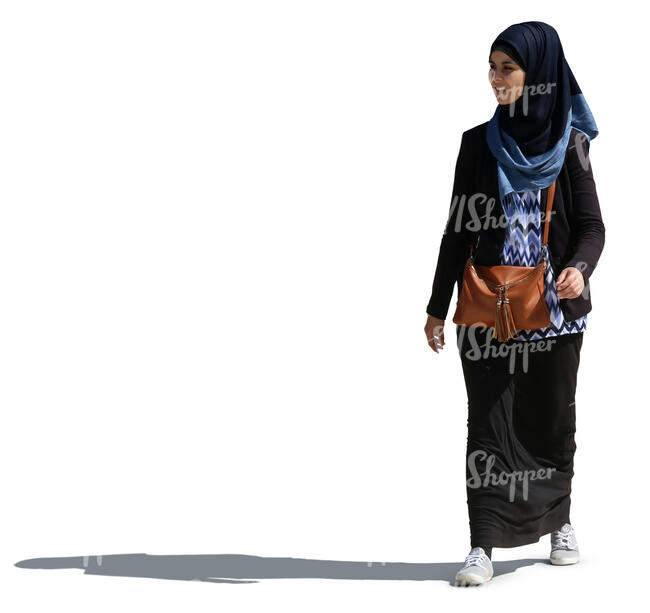 young smiling muslim woman walking on a sunny day