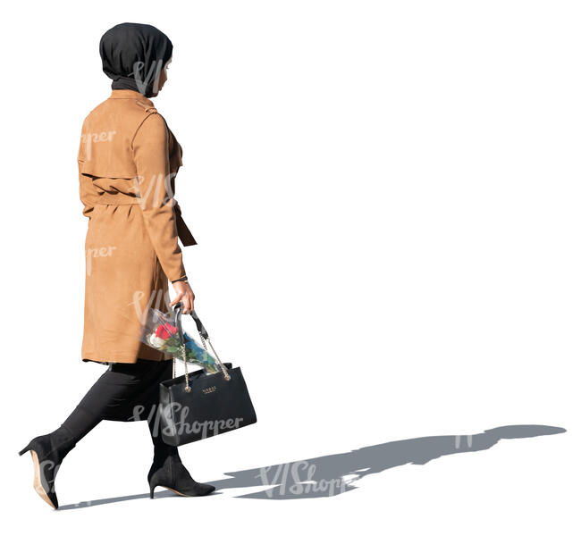 muslim woman with flowers in her bag walking