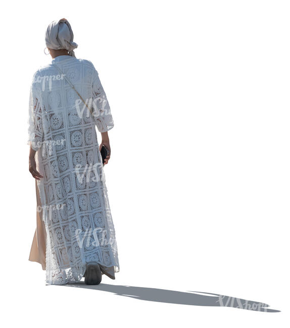 cut out backlit woman in a white long jacket and headscarf walking