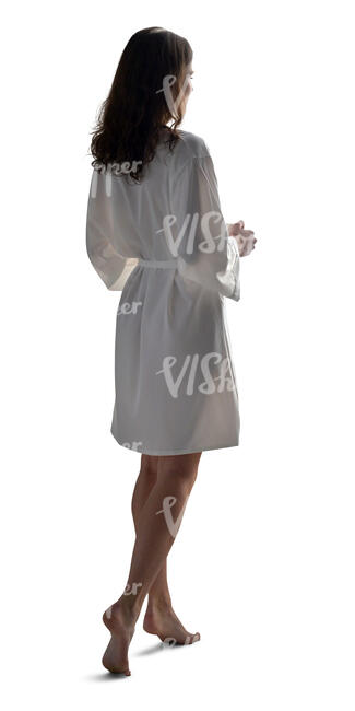 cut out woman in a white silky bathrobe standing and drinking coffee