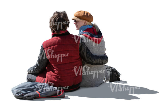 cut out backlit couple in autumn sitting seen from back angle