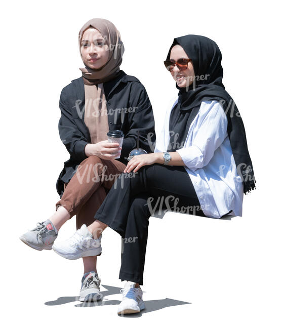 two cut out young muslim girls sitting