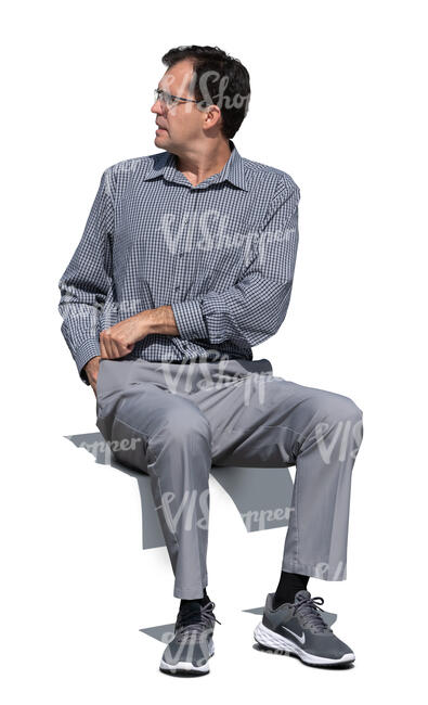 cut out man sitting outside and looking over his shoulder
