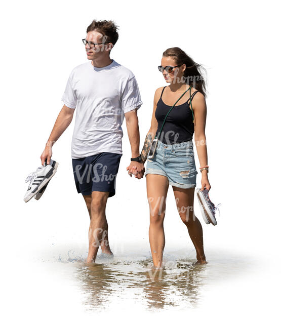 cut out young couple walking hand in hand on the beach in water