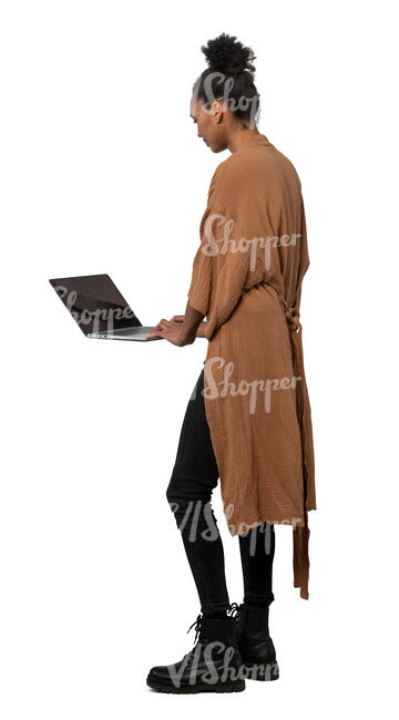 cut out woman standing at a table and working with a laptop