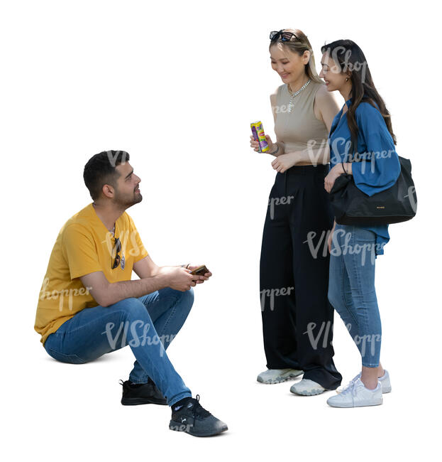 cut out man sitting and talking to two women standing beside him