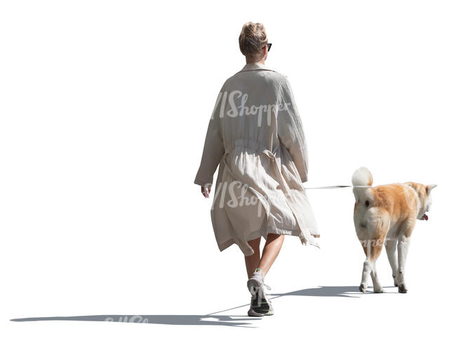 cut out woman in a flowy white jacket walking a dog