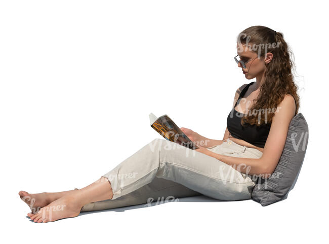 cut out woman sitting on a sofa and reading a book