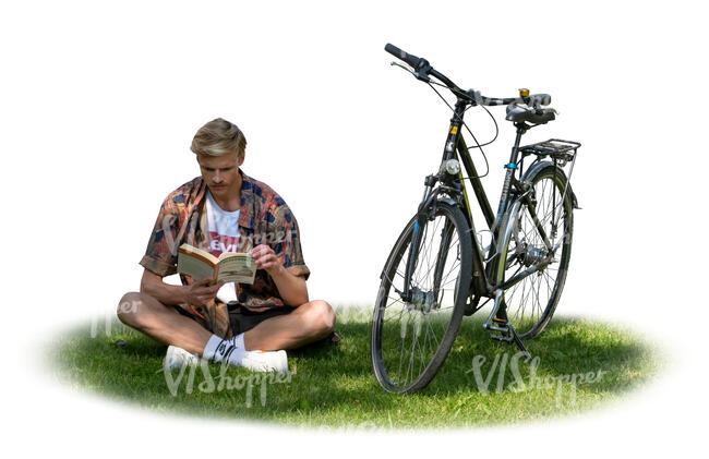 cut out man sitting on the grass in a tree shade and reading a book