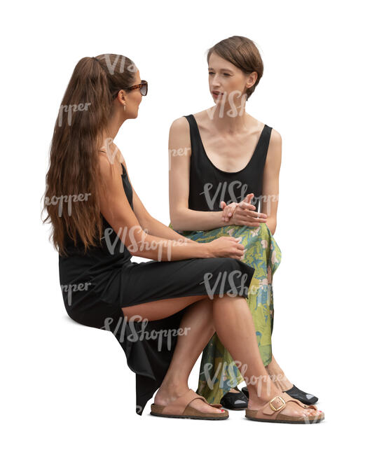 two cut out women sitting and talking